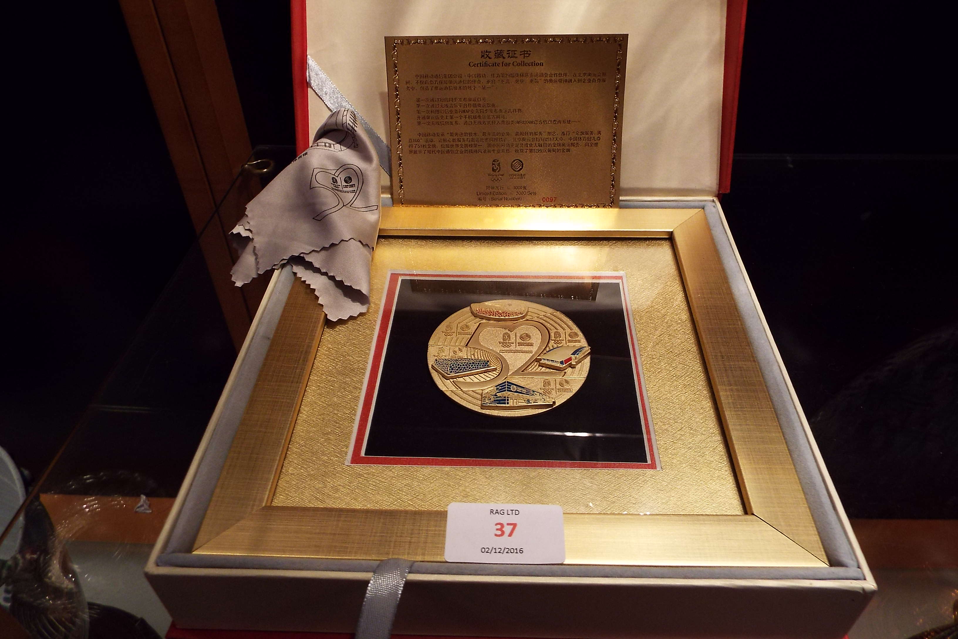 An Beijing 2008 Olympic framed medallion depicting four stadiums boxed and certificate