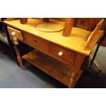 A Victorian pine wash stand with shaped 3/4 gallery top over two frieze drawers and under-tier