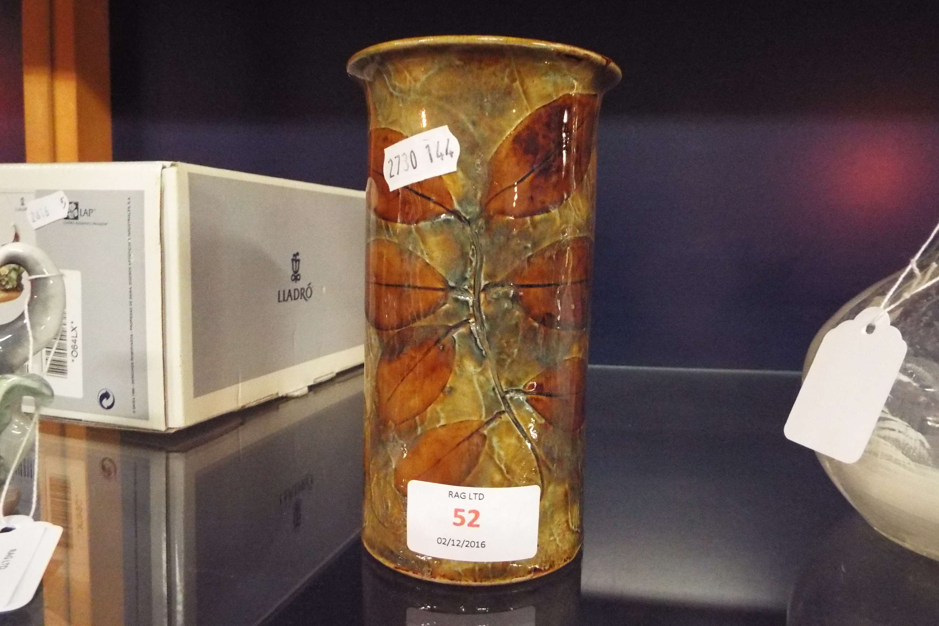 A Royal Doulton tubular vase with leaf pattern