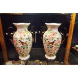 A pair of Victorian hand-painted twin handled vases decorated with Great Tits amongst dog roses