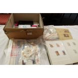 A box of assorted first day covers and used loose stamps