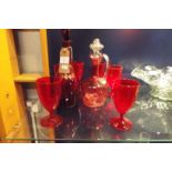 A ruby red glass port decanter and six glasses,