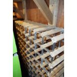 A sixty four section pine galvanised wine rack