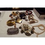 A box of costume jewellery, compacts,