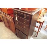 An early 20thC narrow chest of six graduated drawers, each with drop ring handles,