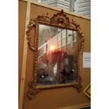 A late 18thC / early 19thC gilt gesso mirror decorated with swags and garlands surmounted by a