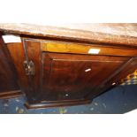 A Georgian mahogany corner cupboard having brass 'H' hinges the panelled door enclosing two shelves