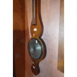 A Negretti Zambra of London barometer/thermometer set in a mahogany case