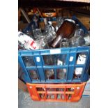 Two crates of vintage milk bottles in various shapes,