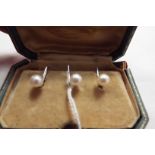 A boxed set of three telescopic white metal and pearl studs