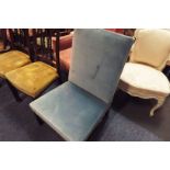 An early 20thC blue velvet upholstered bedroom chair raised on square supports