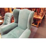 A good quality early 20thC serpentine wing back armchair