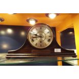 An oak cased mantle clock having Roman numerals