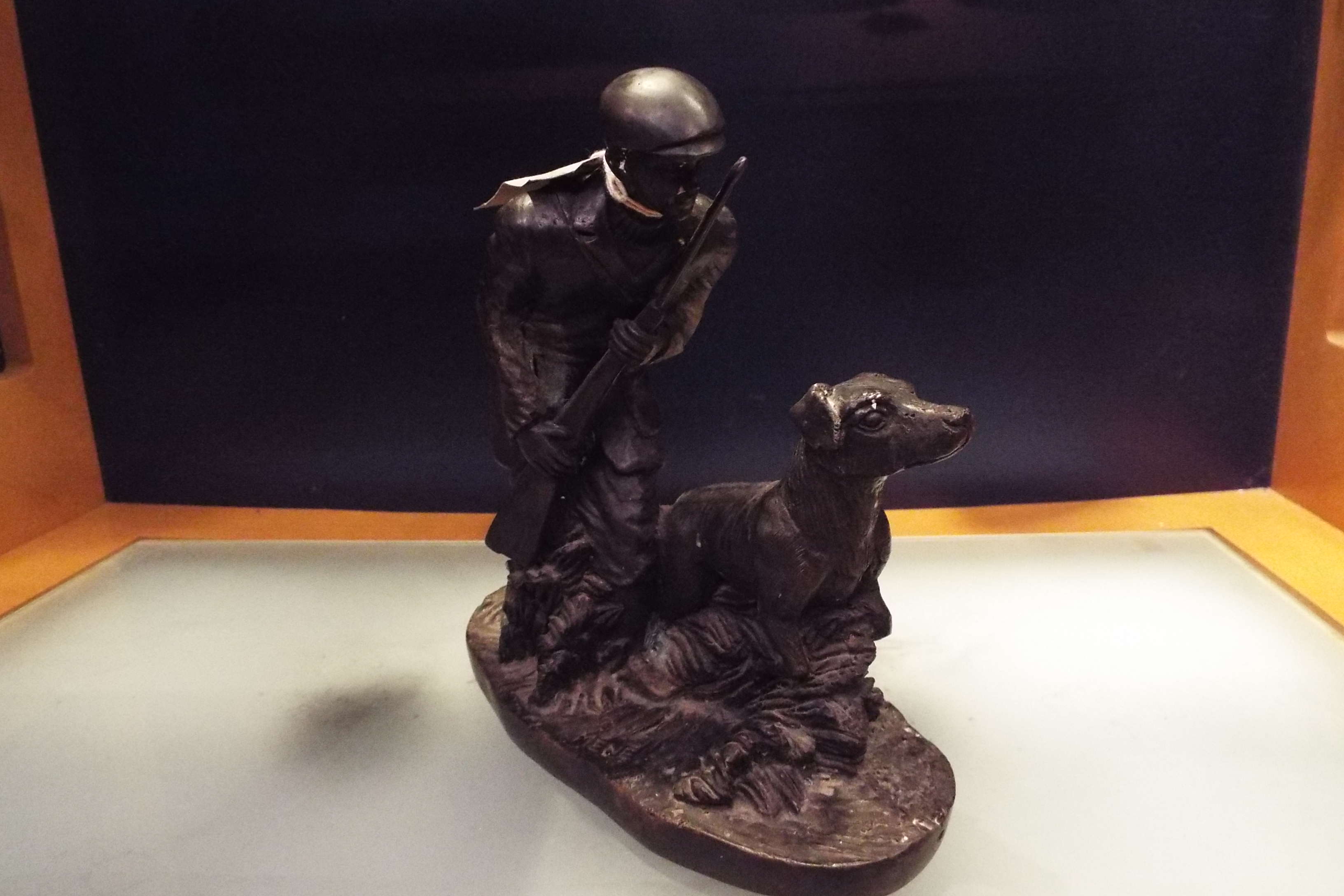 A bronze figural group depicting gamekeeper and hound,
