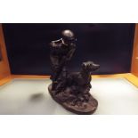 A bronze figural group depicting gamekeeper and hound,