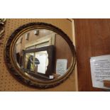 An oval gilt framed mirror