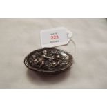 A Dutch silver patch box having putti decoration to the lid enclosing a gilded interior with