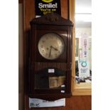 A 1920s/30s walnut cased wall clock with silvered dial and viewing panel below complete with