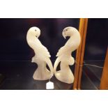 A pair of carved soapstone Parakeets with glass eyes