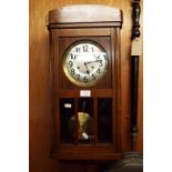 An oak cased wall clock