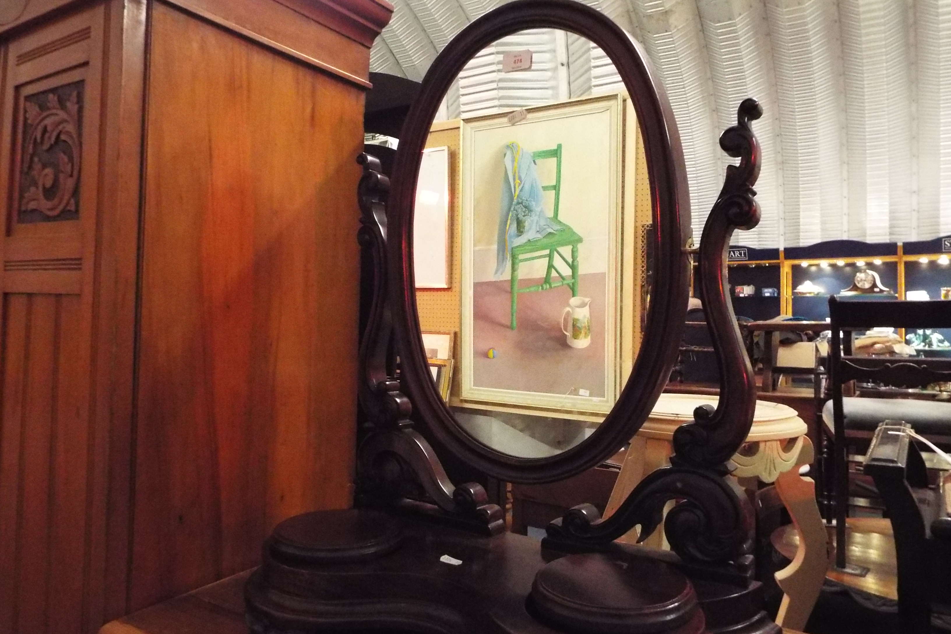 A stained wood swivel dressing mirror