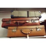 A mid-20thC leather suitcase with brass