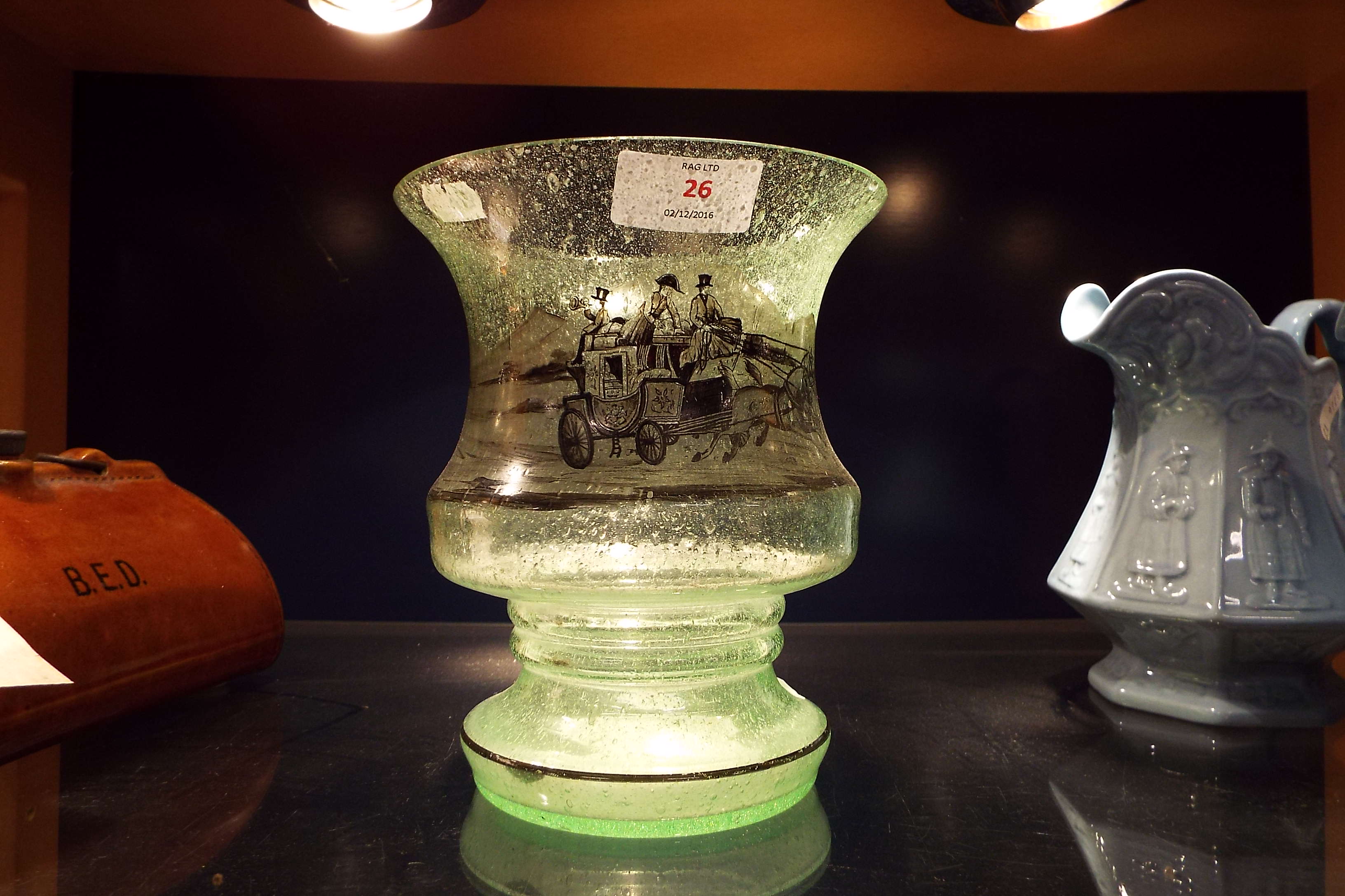 A frosted glass vase having coaching sce