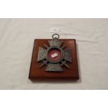 A WWI French memorial cross on wooden pl