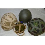 Three British military issue Combat 95 helmets and a water canteen