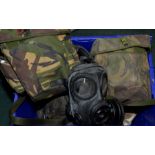 Large quantity of various military issue respirators with haversacks etc