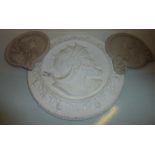 Circular plaster plaque and two resin plaques depicting female portraits