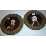 Pair of porcelain plates depicting head and shoulder portraits of Nuns in embossed copper frames