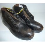 Pair of small early leather clogs