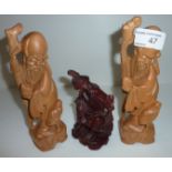 Two lightwood Oriental carved wooden figures and one other
