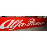 Two very large plastic Alfa Romeo advertising signs