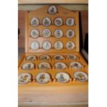 Two wooden display cases with selection of miniature Hummel plates