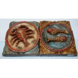 Two carved wooden panels depicting Pisces & Cancer astrology signs