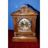Mahogany cased mantel clock with brass and steel face and carved detail with Corinthian column