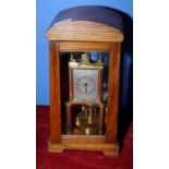 Early 20th C oak cased 400 day mantel clock with square steel face with twin brass pillar supports,