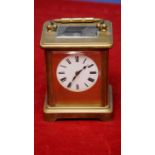 French brass cased carriage clock with white enamel dial bevelled edged glass panels