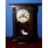 Unusual small German wall clock with carved and stained case and white enamel dial marked Unghans J,