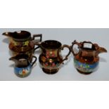 Four copper lustre jugs with enamel painted decoration