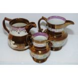 Three copper lustre jugs with painted detail
