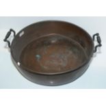 Large shallow copper dish with twin handles