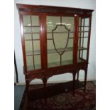 Edwardian mahogany break front glazed display cabinet with central glazed door with shield detail