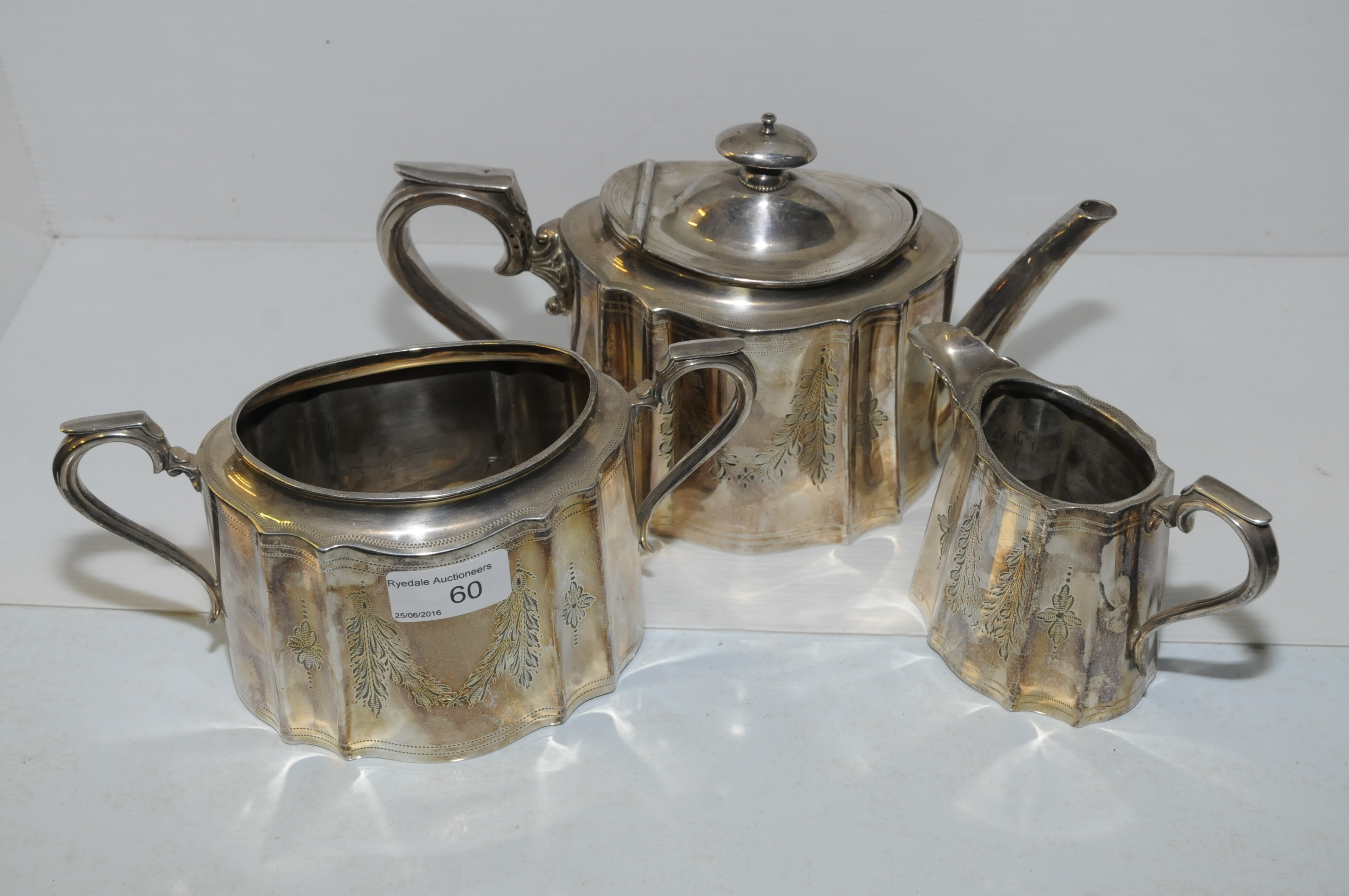 Three piece silver plated tea set with bright cut engraving