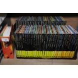 Selection of 'Classic Composers' cds and booklets on wooden display shelves (in unopened packets)