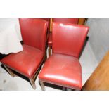 Set of five red leather retro style chairs on oak supports