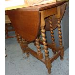 Light oak drop leaf table on barley twist supports