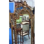 Extremely large gilt framed bevel edged wall mirror with elaborately carved frame